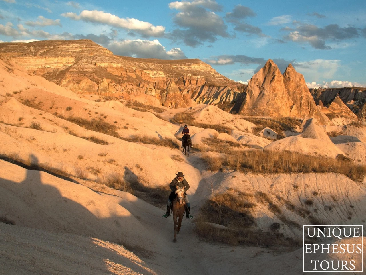 horseback-riding-trail-cappadocia-rock-formations-golden-hour-turkey